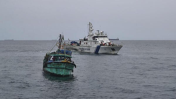 <div class="paragraphs"><p>Indian Coast Guard personnel reach out to fishermen at sea, asking them to return to the shores due to the depression in the Bay of Bengal.</p></div>