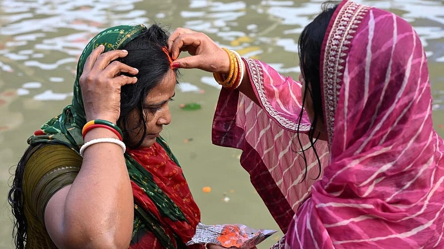 <div class="paragraphs"><p>Women perform rituals while observing 'Chhath Puja'.</p></div>