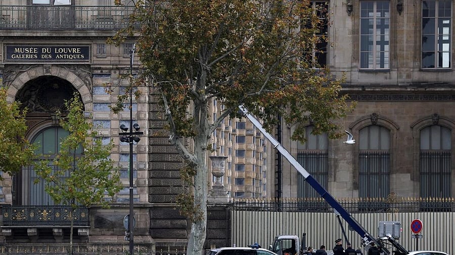 <div class="paragraphs"><p>Police officers work near a crane believed to have been used in what the French Interior Ministry said was a robbery at the Louvre museum during which jewellery was stolen, in Paris, France.</p></div>