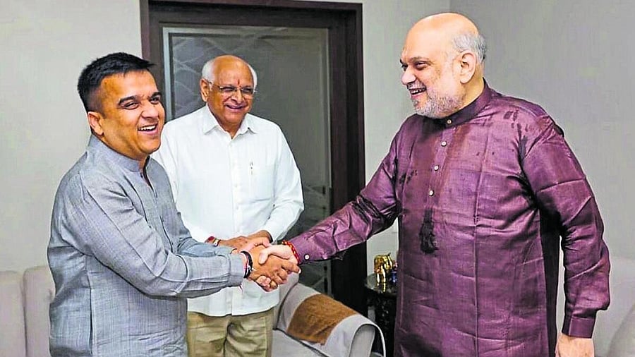 <div class="paragraphs"><p>Union Home Minister Amit Shah being greeted by Gujarat Minister Harsh Sanghavi on his birthday as Chief Minister Bhupendra Patel looks on.</p></div>