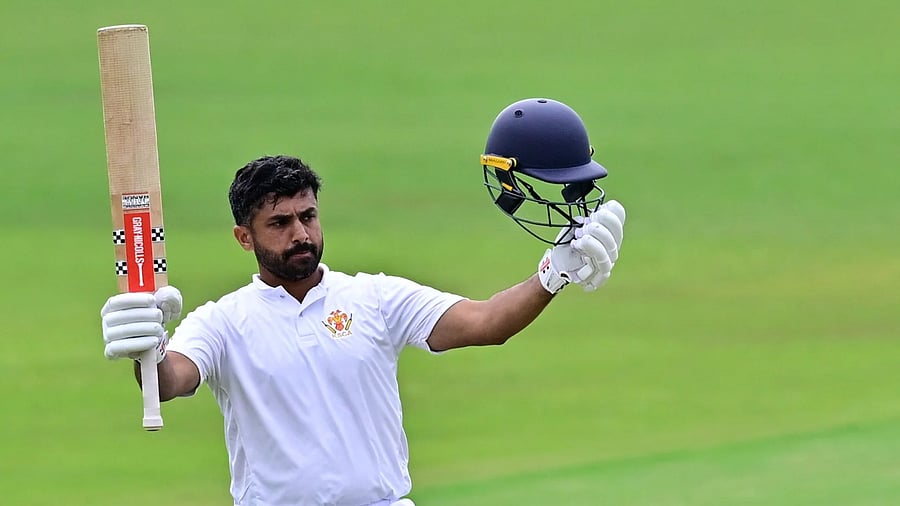 <div class="paragraphs"><p>Karnataka's Karun Nair celebrates after scoring a century against Goa on the second day of their Ranji Trophy clash in Shivamogga on Sunday. </p></div>