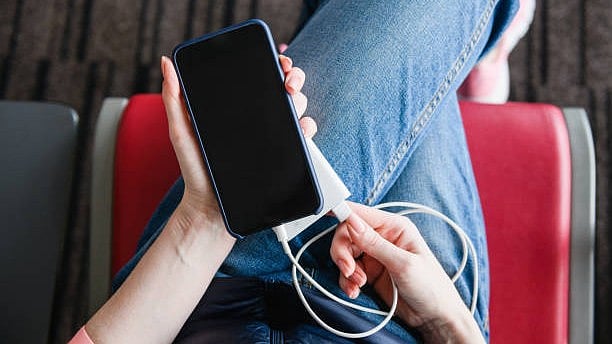 <div class="paragraphs"><p>Representative image of a person using power bank in a flight.</p></div>