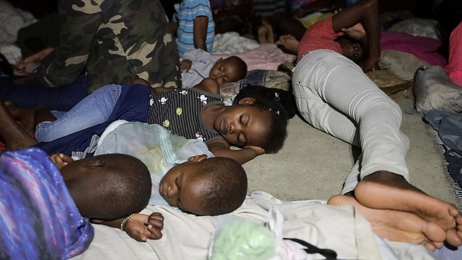 <div class="paragraphs"><p>People sleep at a school turned shelter while Haiti is seeing downpours from the outer bands of Hurricane Melissa, as the storm is churning towards Cuba, after making landfall in Jamaica, in Les Cayes, Haiti.</p></div>