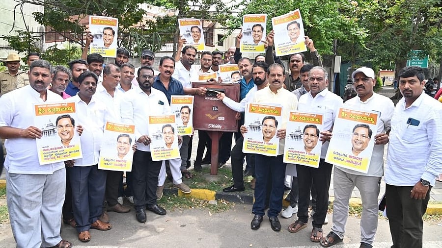 <div class="paragraphs"><p>Members of Ahinda Sangatanegalu (Ahinda Organisations) post letters to Opposition Leader in the Lok Sabha Rahul Gandhi, urging him to declare Chief Minister Siddaramaiah for the full five-year term, in Mysuru, on Wednesday. Karnataka State Backward Classes Awareness Forum president K S Shivaramu is seen. </p></div>
