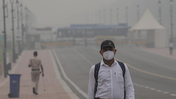 <div class="paragraphs"><p>A commuter wears a mask as a layer of smog engulfs the city after deterioration in air quality in Delhi-NCR.</p></div>