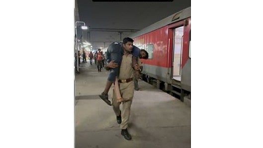 <div class="paragraphs"><p>UP Police officer Ashwani Kumar carrying a disabled man on his shoulders.</p></div>