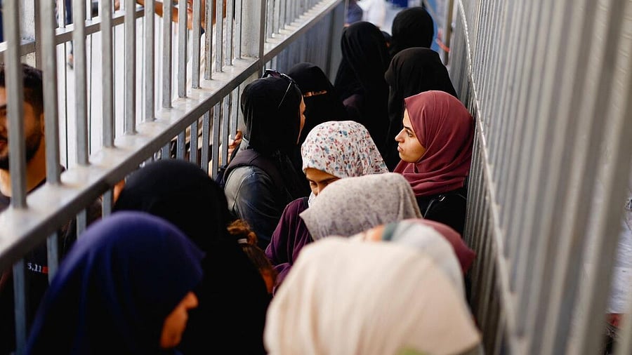 <div class="paragraphs"><p>People queue outside the Bank of Palestine amid a cash shortage, in Nuseirat, central Gaza Strip.</p></div>