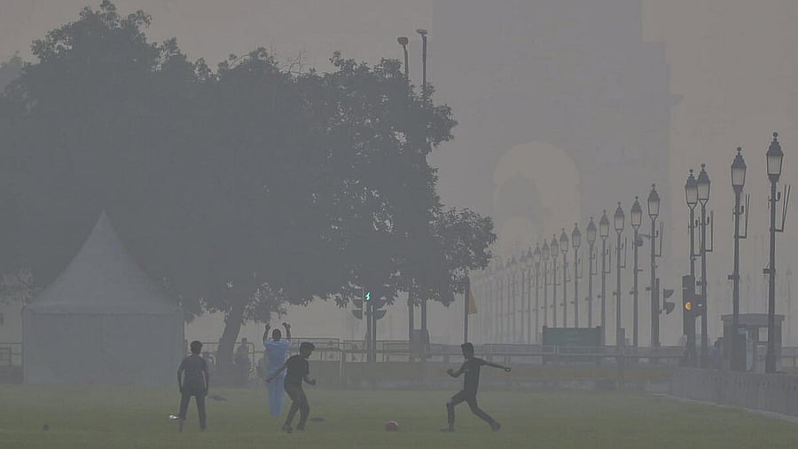 <div class="paragraphs"><p>Children playing football near India Gate in New Delhi as smog engulfs the area.</p></div>