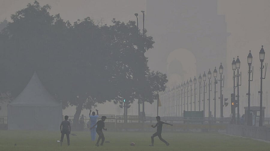 <div class="paragraphs"><p>Children play football near India Gate as smog engulfs the area, with the Air Quality Index (AQI) remaining in the 'very poor' category, in New Delhi.</p></div>