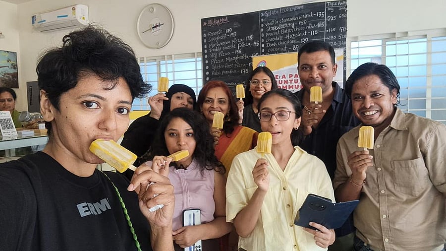 Attendees of a potluck meetup organised by Cafe Zero, enjoying vegan mango popsicles.  
