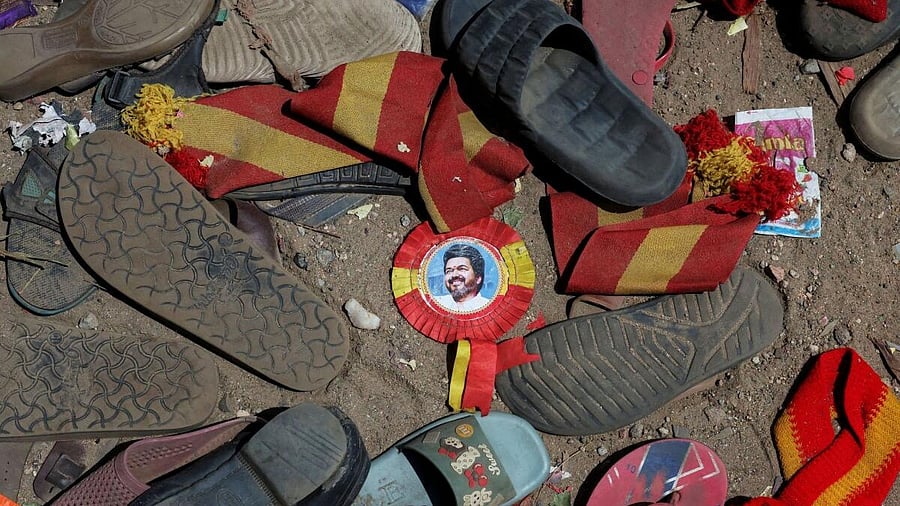 <div class="paragraphs"><p>A badge with picture of Vijay, actor and politician, lies amid footwears and other belongings left by attendees at the site of a stampede incident during an election campaign rally held by Tamilaga Vettri Kazhagam party, in Karur district of Tamil Nadu.</p></div>