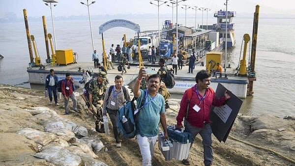 <div class="paragraphs"><p>Polling officials and security personnel deboard a ferry as they leave for election duty on the eve of the first phase of the Bihar Assembly elections, in Patna</p></div>
