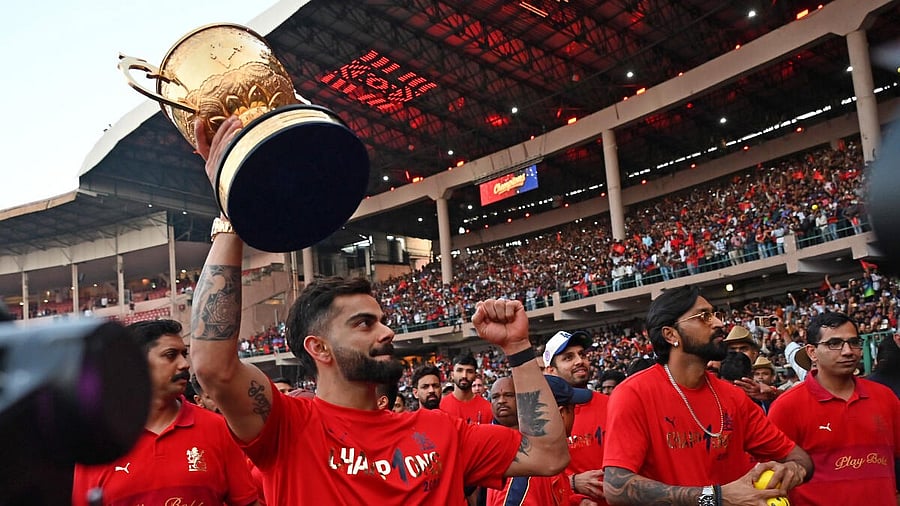 <div class="paragraphs"><p>Virat Kohli celebrates with trophy during RCB's victory parade in Bengaluru in June.</p></div>