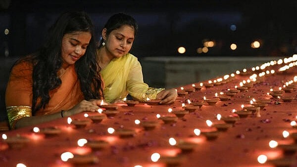 <div class="paragraphs"><p>People light earthen lamps on the occasion of Dev Deepavali.</p></div>