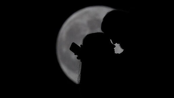 <div class="paragraphs"><p>A couple's silhouette as a super moon, known as the Hunter's Moon, rises over Tirana, Albania.</p></div>