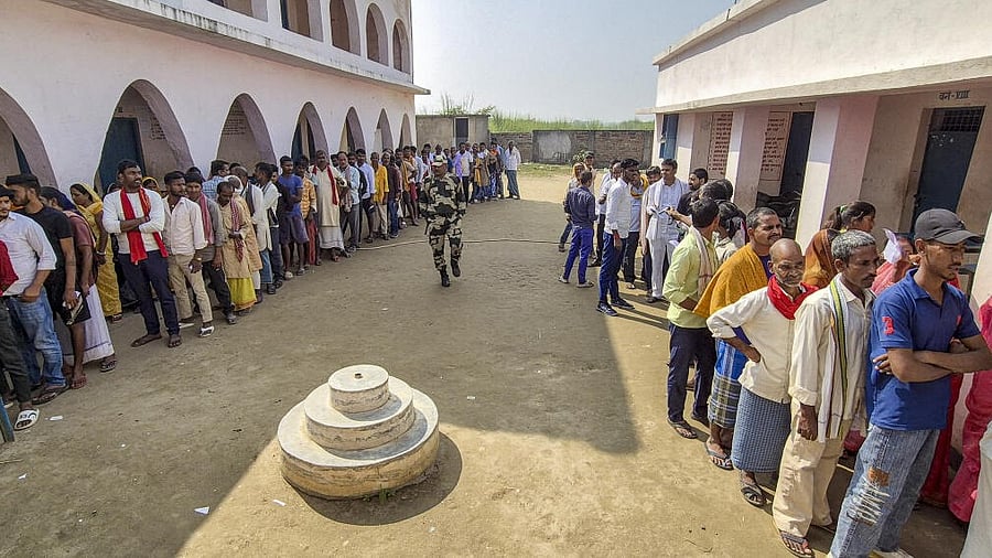 <div class="paragraphs"><p>Voters wait in a queue to cast votes at a polling station during the first phase of the Bihar Assembly elections, at Hajipur in Vaishali.</p></div>