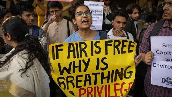 <div class="paragraphs"><p>Protesters hold placards and chant slogans during a demonstration demanding immediate government action to address air pollution in New Delhi</p></div>
