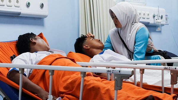 <div class="paragraphs"><p>A relative gestures while injured students lie at Jakarta Islamic hospital after an explosion occurred during Friday prayers at a mosque inside a school complex in Jakarta, Indonesia.</p></div>