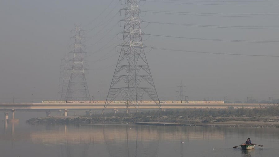 <div class="paragraphs"><p>A man rows his boat in the Yamuna river on a smoggy morning in the old quarters of Delhi.</p></div>