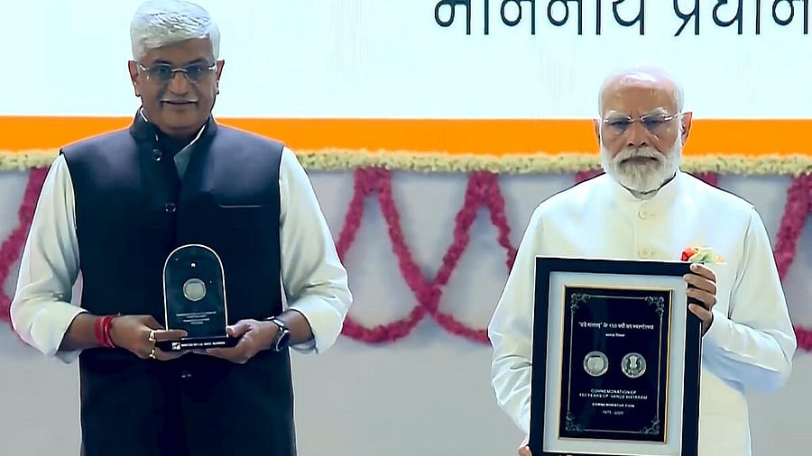 <div class="paragraphs"><p>In this screengrab from a video posted on Nov. 17, 2025, Prime Minister Narendra Modi, right, and Union Minister of Culture and Tourism Gajendra Singh Shekhawat release commemorative stamp during an event marking 150 years of the national song ‘Vande Mataram’, at the Indira Gandhi Indoor (IGI) Stadium, in New Delhi.</p></div>
