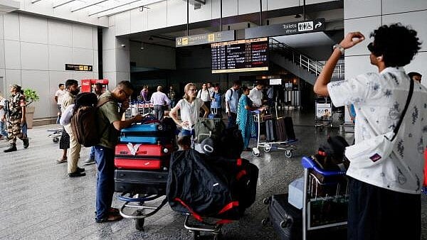 <div class="paragraphs"><p>Passengers wait at Terminal 2 of Indira Gandhi International Airport in New Delhi.</p></div>