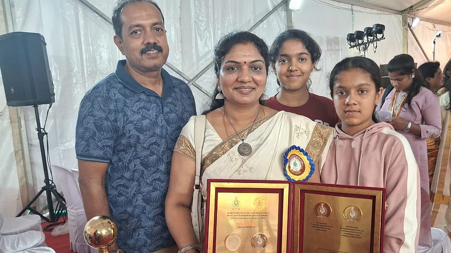 <div class="paragraphs"><p>V Latha with her family.</p></div>