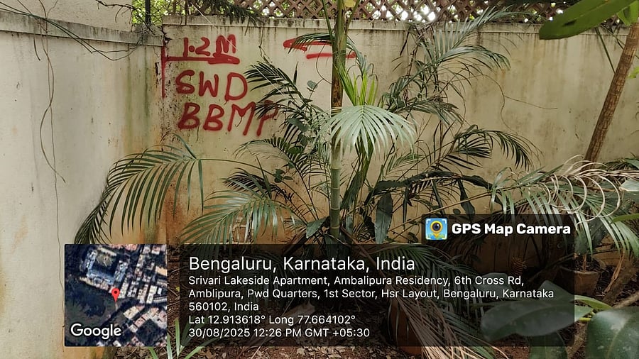 A marking on a compound wall around Ambalipura Lake shows the extent of encroachment by apartment complexes. 