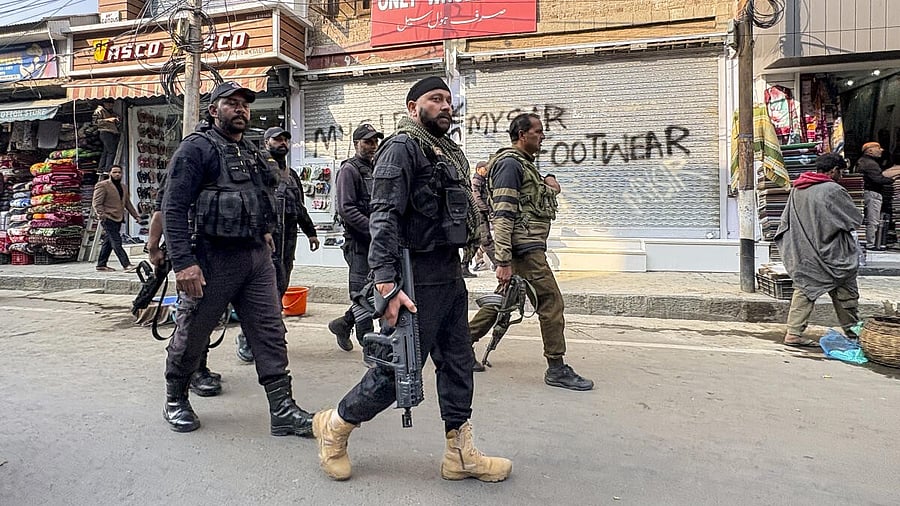 <div class="paragraphs"><p>Security personnel stand guard following the arrest of Dr. Adeel (a resident of Wanpora, Kulgam), accused in an interstate and transnational terror module, in Anantnag, Monday, Nov. 10, 2025. The arrest and subsequent terror module bust were results of a joint operation by the Faridabad and Jammu and Kashmir Police. </p></div>