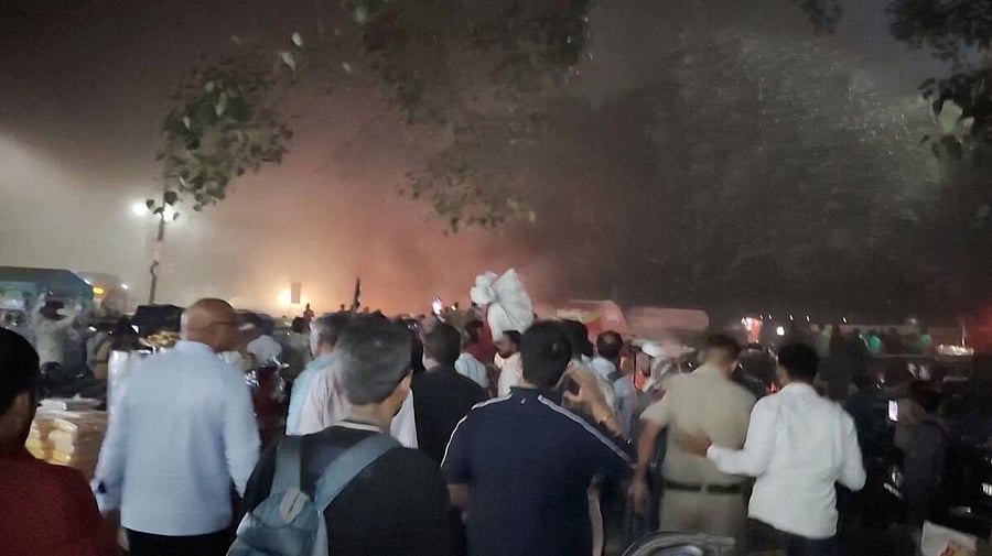 <div class="paragraphs"><p>People gather near a subway entrance following a deadly explosion near the historic Red Fort in the old quarters of Delhi.</p></div>