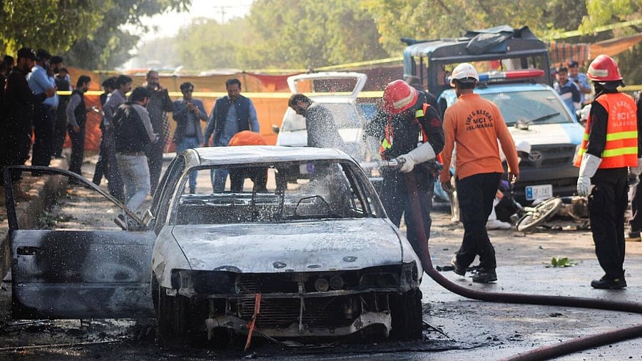<div class="paragraphs"><p>Firefighter douses a vehicle after a blast outside a court building in Islamabad, Pakistan</p></div>