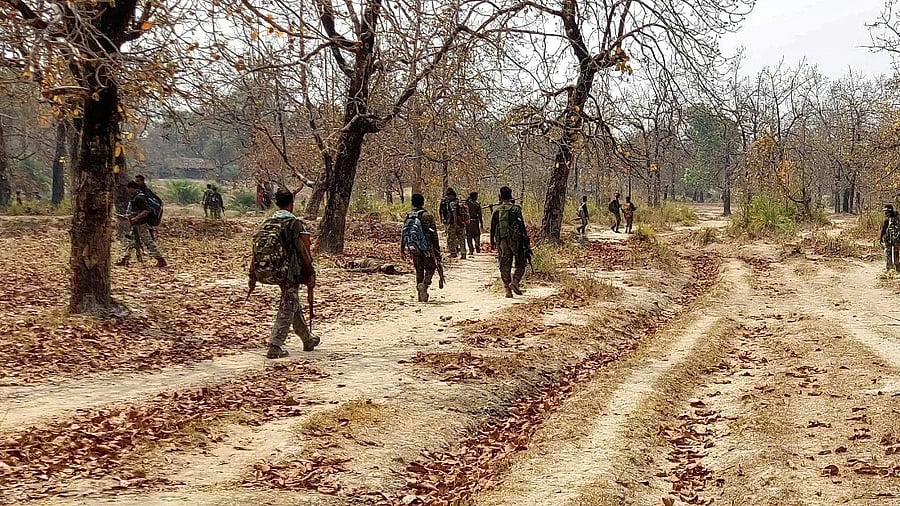 <div class="paragraphs"><p>Security force personnel patrol in a Maoist region </p></div>