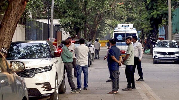 <div class="paragraphs"><p>People gather as veteran actor Dharmendra is brought to his residence in an ambulance following his discharge from the hospital, in Mumbai.</p></div>