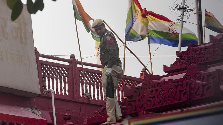<div class="paragraphs"><p>A police official searches for evidence in the premises of Sri Digambar Jain Lal temple in the aftermath of a blast in the area, opposite Red Fort</p></div>