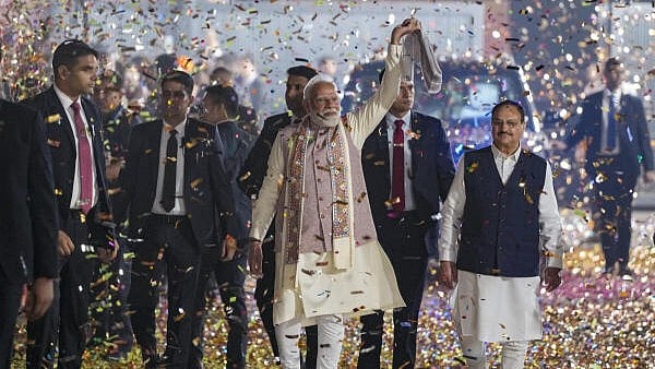 <div class="paragraphs"><p>Prime Minister Narendra Modi waves a ‘gamcha’ as he arrives during the celebration of NDA’s victory in the Bihar Assembly elections, at BJP headquarters, in New Delhi.</p></div>