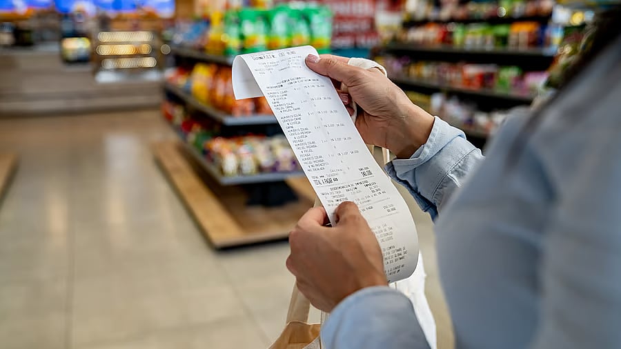 <div class="paragraphs"><p>Person holding a receipt of groceries representing food prices.</p></div>