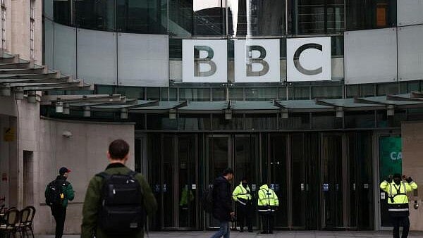 <div class="paragraphs"><p>People walk outside BBC Broadcasting House.</p></div>