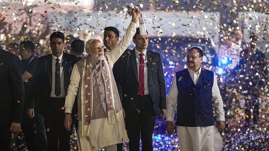 <div class="paragraphs"><p>Prime Minister Narendra Modi waves a ‘gamcha’ as he arrives during the celebration of NDA’s victory in the Bihar Assembly elections, at BJP headquarters, in New Delhi with Union Health Minister and BJP National President JP Nadda.</p></div>