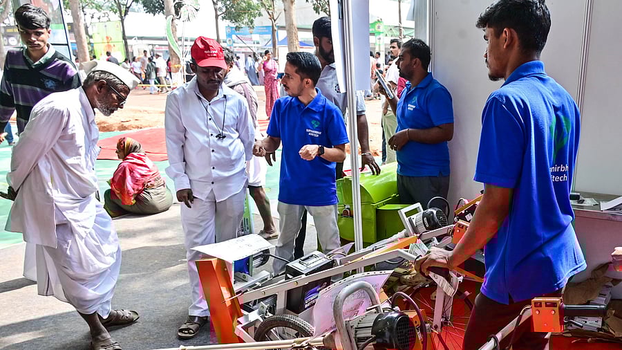 <div class="paragraphs"><p>Farmers inspect a tool on sale on the final day of Krishi Mela in Bengaluru on Sunday. </p></div>