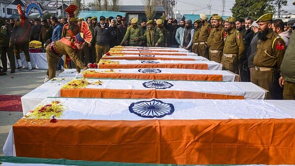 <div class="paragraphs"><p>Police and security personnel pay tribute to the nine persons killed in the accidental blast at Nowgam police station.</p></div>