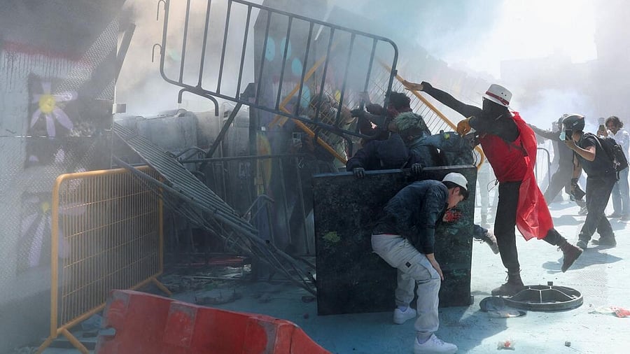 <div class="paragraphs"><p>Demonstrators dismantle parts of a barrier protecting the National Palace during a protest against insecurity and corruption in the country, in the Zocalo square, in Mexico City, Mexico.</p></div>