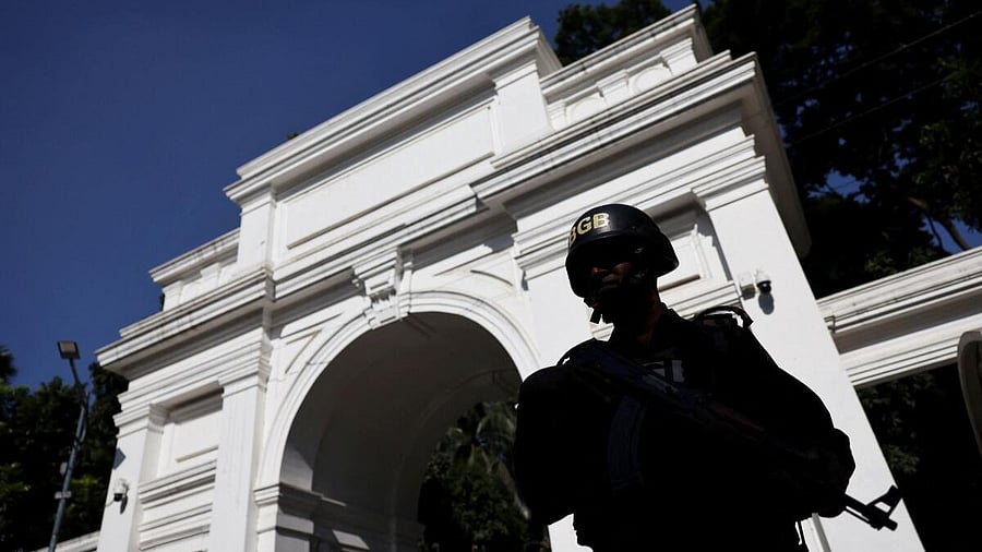 <div class="paragraphs"><p>A member of the security personnel stands guard in front of the court </p></div>