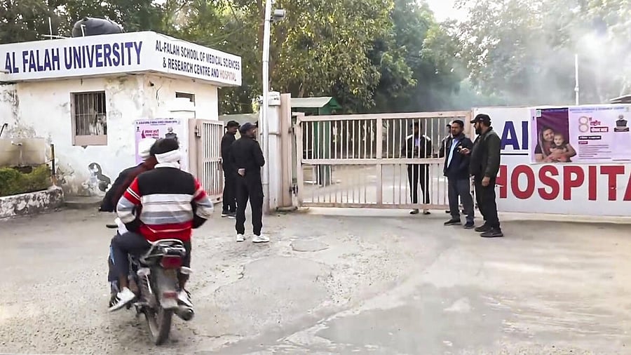 <div class="paragraphs"><p>People outside Al Falah University, after Delhi Police have detained three people, including two doctors from the university, in connection with the blast near the Red Fort, in Faridabad, Monday, Nov. 17, 2025.</p></div>