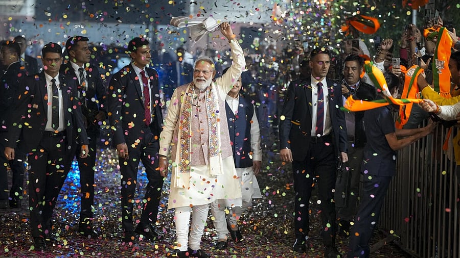 <div class="paragraphs"><p>Prime Minister Narendra Modi waves a ‘gamcha’ as he arrives during the celebration of NDA’s victory in the Bihar Assembly elections, at BJP headquarters, in New Delhi.</p></div>