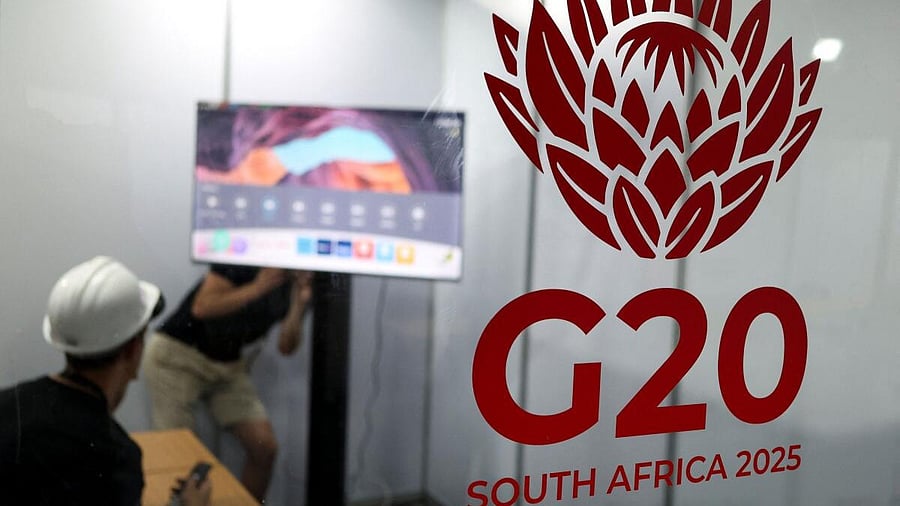 <div class="paragraphs"><p>Workers appear behind a G20 logo as South Africa prepares to host the G20 Summit in Johannesburg from November 22 to 23, in Johannesburg, South Africa, November 13, 2025.</p></div>