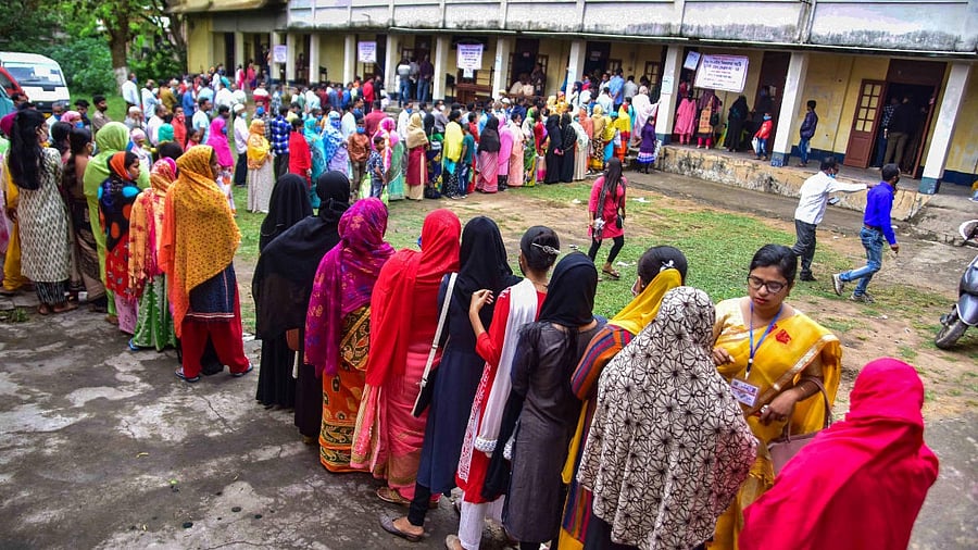 <div class="paragraphs"><p>People queuing up outside a polling station in Assam.</p></div>