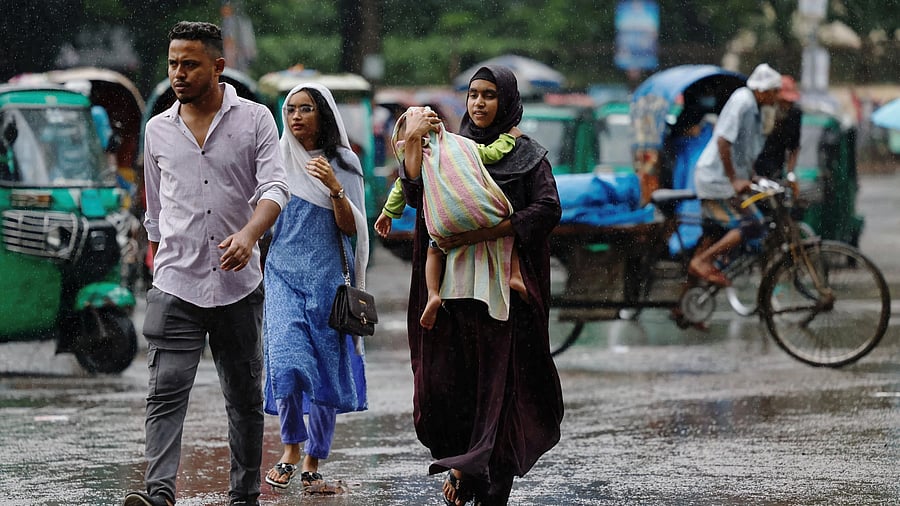 <div class="paragraphs"><p>A family walks in Dhaka, Bangladesh. </p></div>