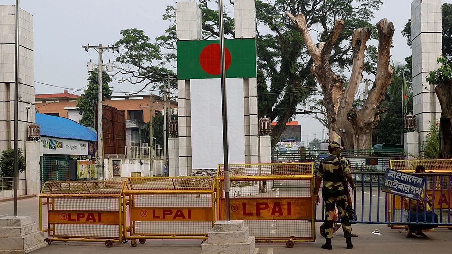 <div class="paragraphs"><p>A Border Security Force official stands in front of the gates of the India-Bangladesh international border.</p></div>
