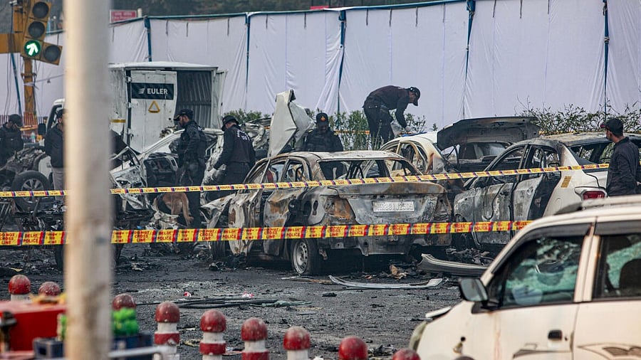 <div class="paragraphs"><p>Charred remains of vehicles at a cordoned off area following a blast that occurred near Red Fort Metro Station.</p></div>