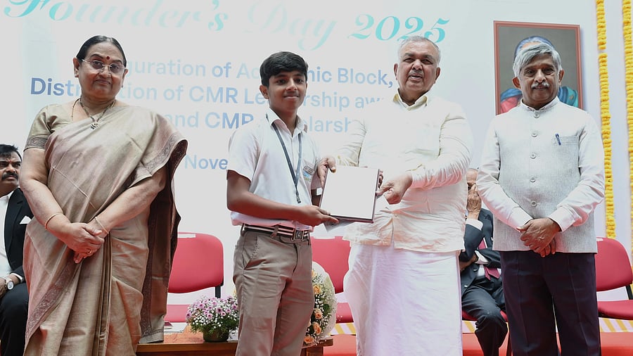 Dr Sabitha Ramamurthy, Chancellor of CMR University; Ramalinga Reddy, Minister for Transport and Muzrai; and Dr KC Ramamurthy, Chairman of CMR Group of Institutions and CMR University, felicitate a student during the Founder's Day celebrations in Bengaluru.