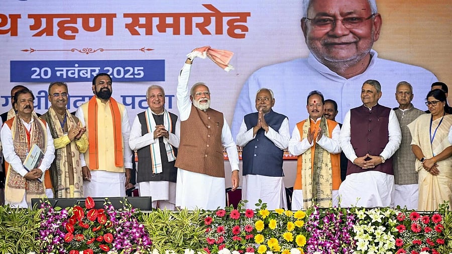 <div class="paragraphs"><p> Prime Minister Narendra Modi waves a ‘gamcha’ during the swearing-in ceremony of NDA government, at Gandhi Maidan in Patna, Thursday, Nov. 20, 2025. Bihar Governor Arif Mohammad Khan, newly sworn-in state Chief Minister Nitish Kumar, state Ministers Samrat Choudhary, Vijay Sinha and others also seen..</p></div>